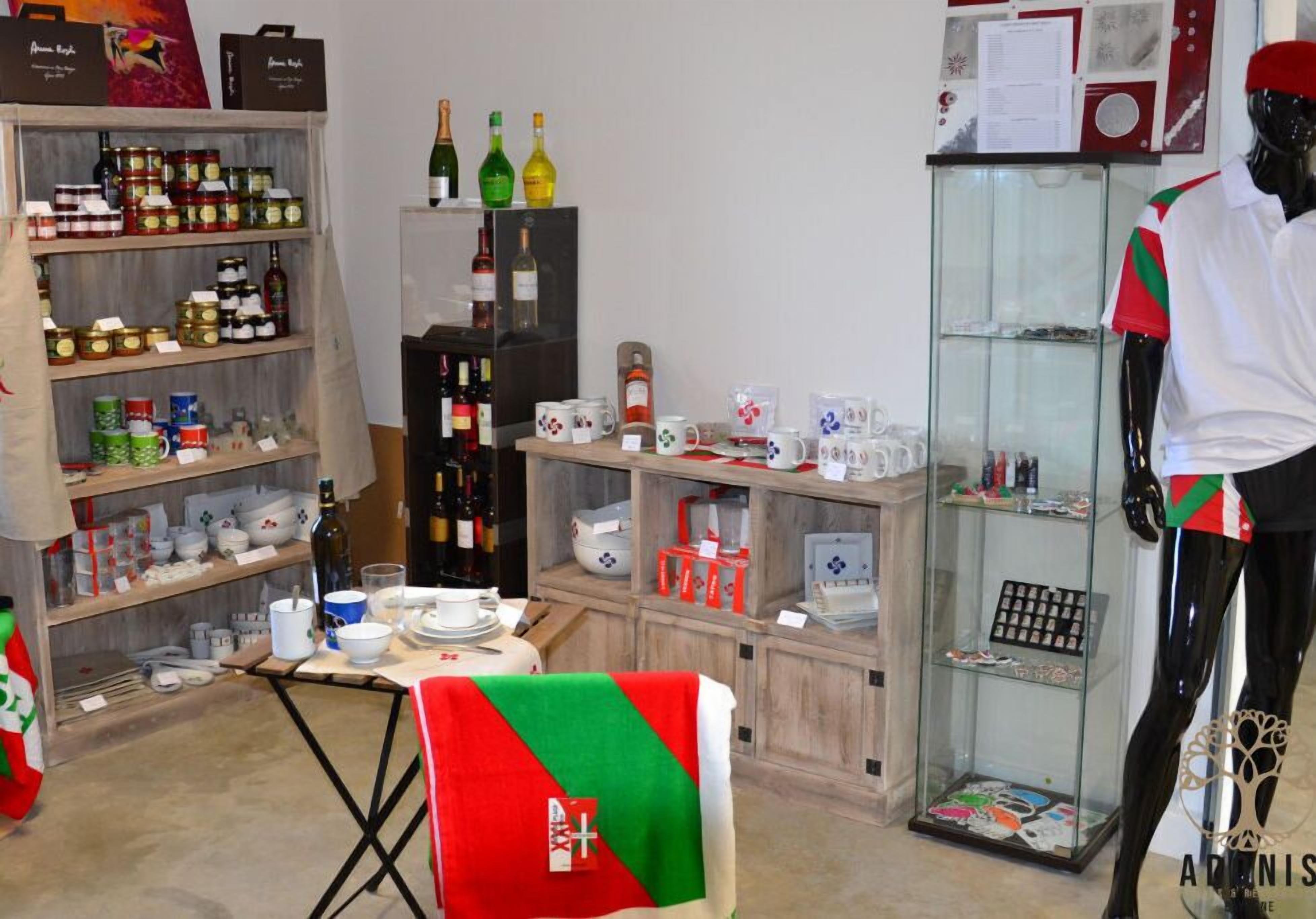 Ein Zimmer mit Regalen voller Küchenutensilien, einer Dame und verschiedenen Flaschen.