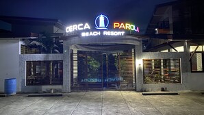 The entrance of Cerca Beach Resort with a prominent sign and a gated entrance.
