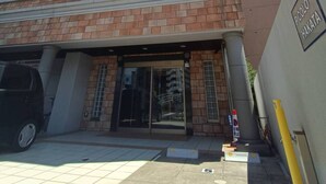 A multi-story building with a brick facade and balconies.