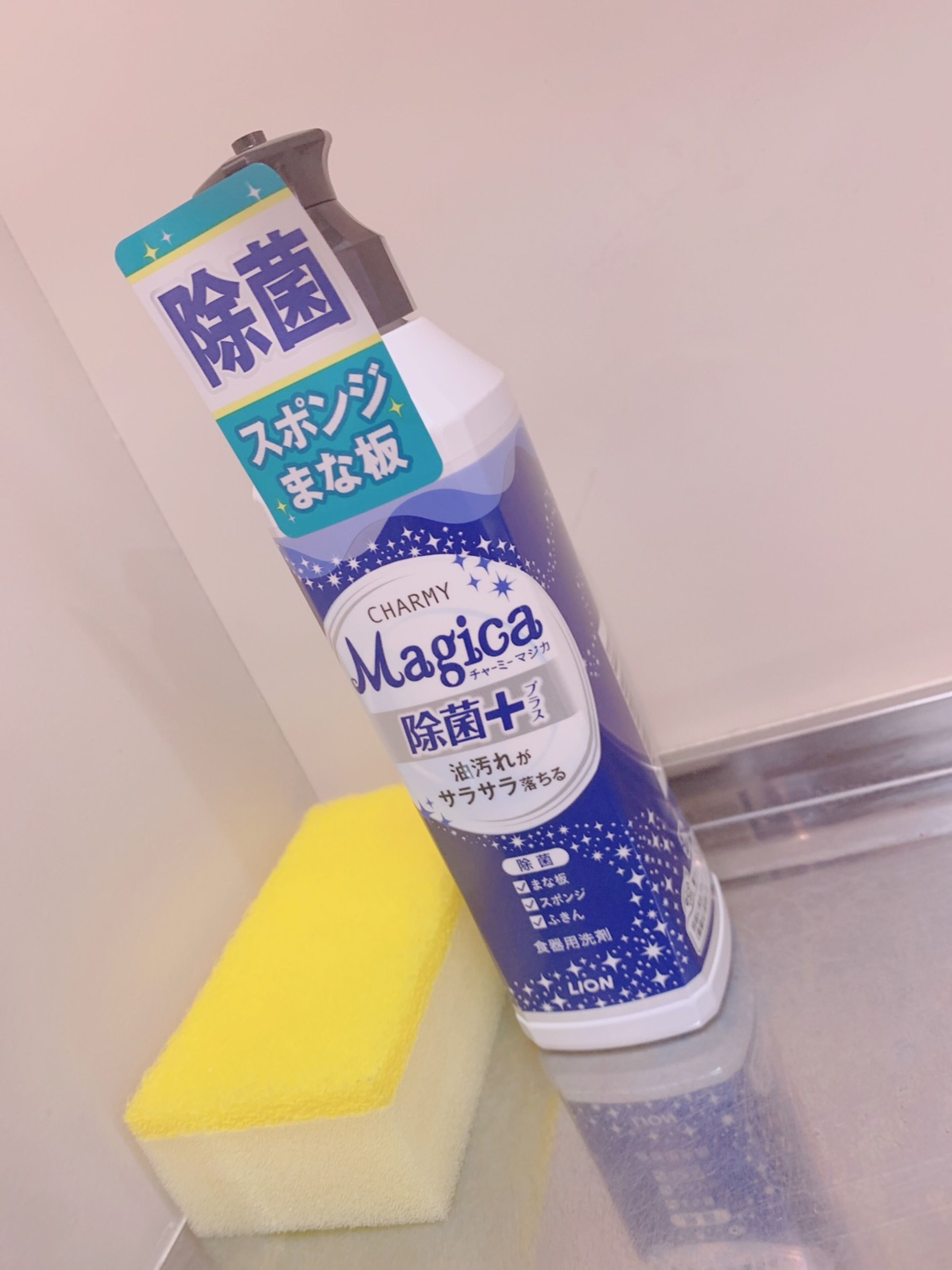 A cleaning product with a blue and white label, a yellow sponge, and a white container.