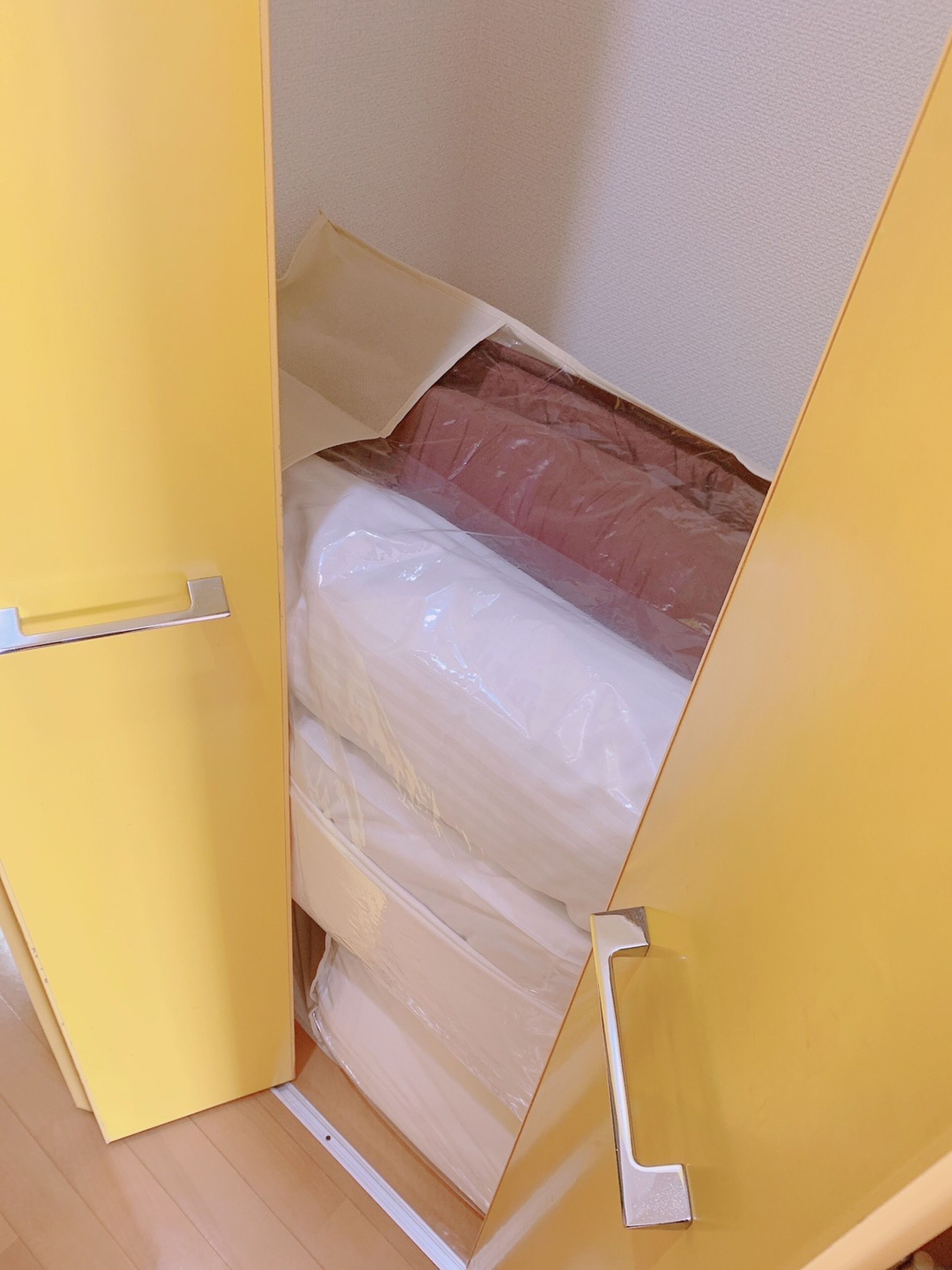 A yellow storage unit with a transparent plastic cover.
