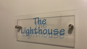 Une pancarte sur une porte portant l’inscription « Le Phare ».