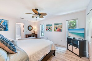 A bedroom with a bed, a ceiling fan, a TV, and artwork on the walls. - Bonita Springs Oasis w/ Wooden Deck & Grill! (Bonita Springs)