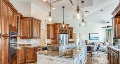 Large corner lot home with canal views & screened in pool - close to the beach