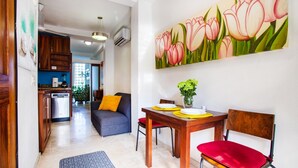 A dining area with a wooden table, red chairs, and a painting of tulips on the wall. - Amazing Villa El Sueno 3 (Puerto Vallarta)