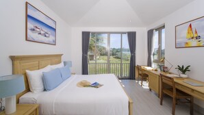 A bedroom with a bed, a desk, and a view of the outdoors. - The Manor Hoi An Villa (Da Nang)