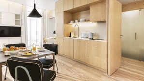 A modern kitchen with wooden cabinets, a dining table with chairs, and a breakfast setup.