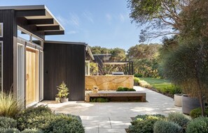 Relax in a serene garden setting with a bench and natural surroundings.