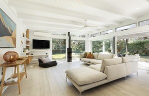 Relax in comfort on the large sectional sofa, surrounded by a stylish coffee table and flat-screen TV.
