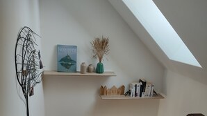 A staircase with wooden railings leading to an upper level with a skylight. - Country house on the edge of a forest with landscaped garden. (Billio)