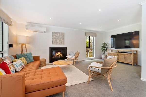 Living room with large Smart TV and gas fireplace