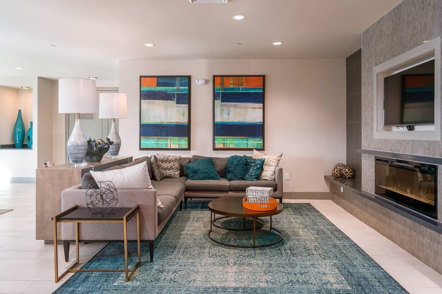 A modern living room with a sofa, coffee table, and artwork on the wall.