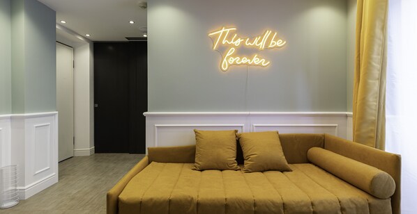 A modern bedroom with a bed, a neon sign on the wall, and a hallway. - Italianway - Corso Venezia 7 (Milan)