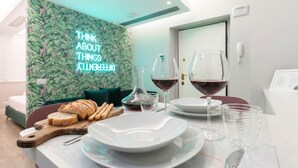 A dining setup with a wooden board, bread, and wine glasses on a table. - Italianway - Corso Venezia 7 (Milan)