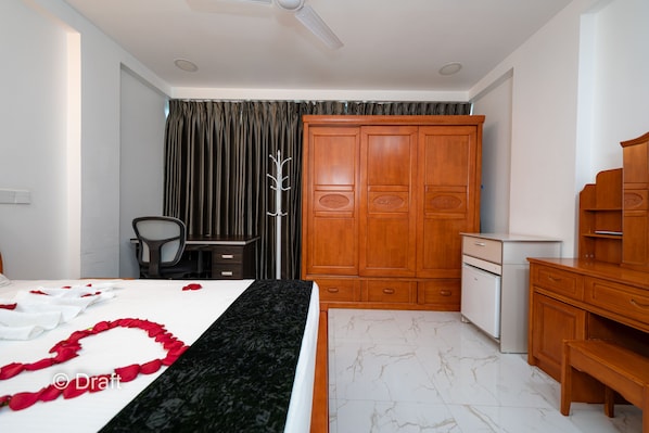 A bedroom with a bed, a wardrobe, a desk, and a chair. - White Beach Holiday (Hulhumalé)