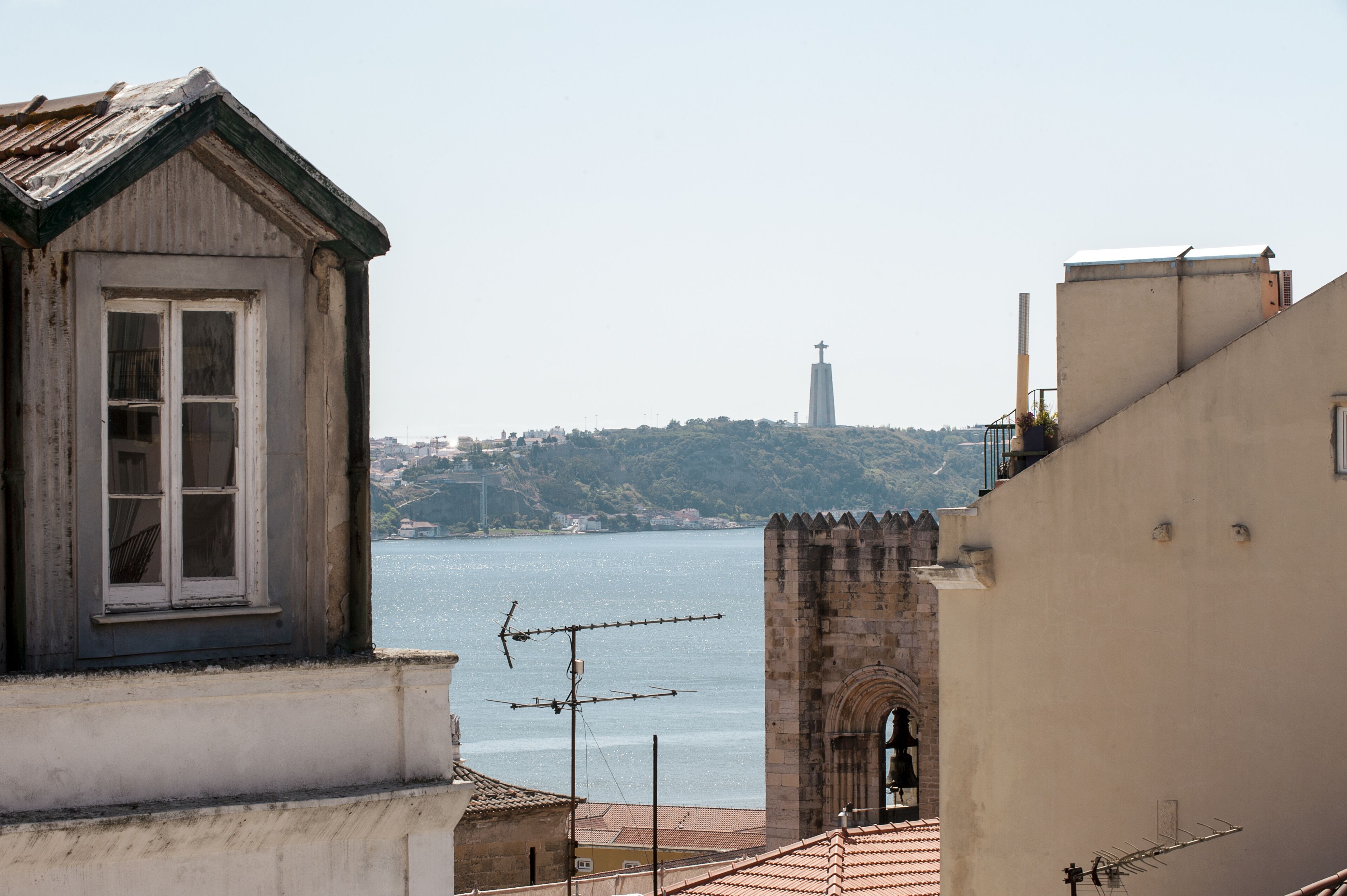 Une vue côtière avec le clocher d ’une église, une tour et un bâtiment dont une fenêtre donne sur la mer.