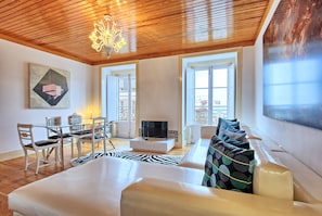 Deluxe Apartment, 2 Bedrooms, Balcony, River View | Living area | Flat-screen TV
