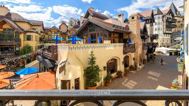 A traditional European-style building with a courtyard, balconies, and outdoor seating areas.