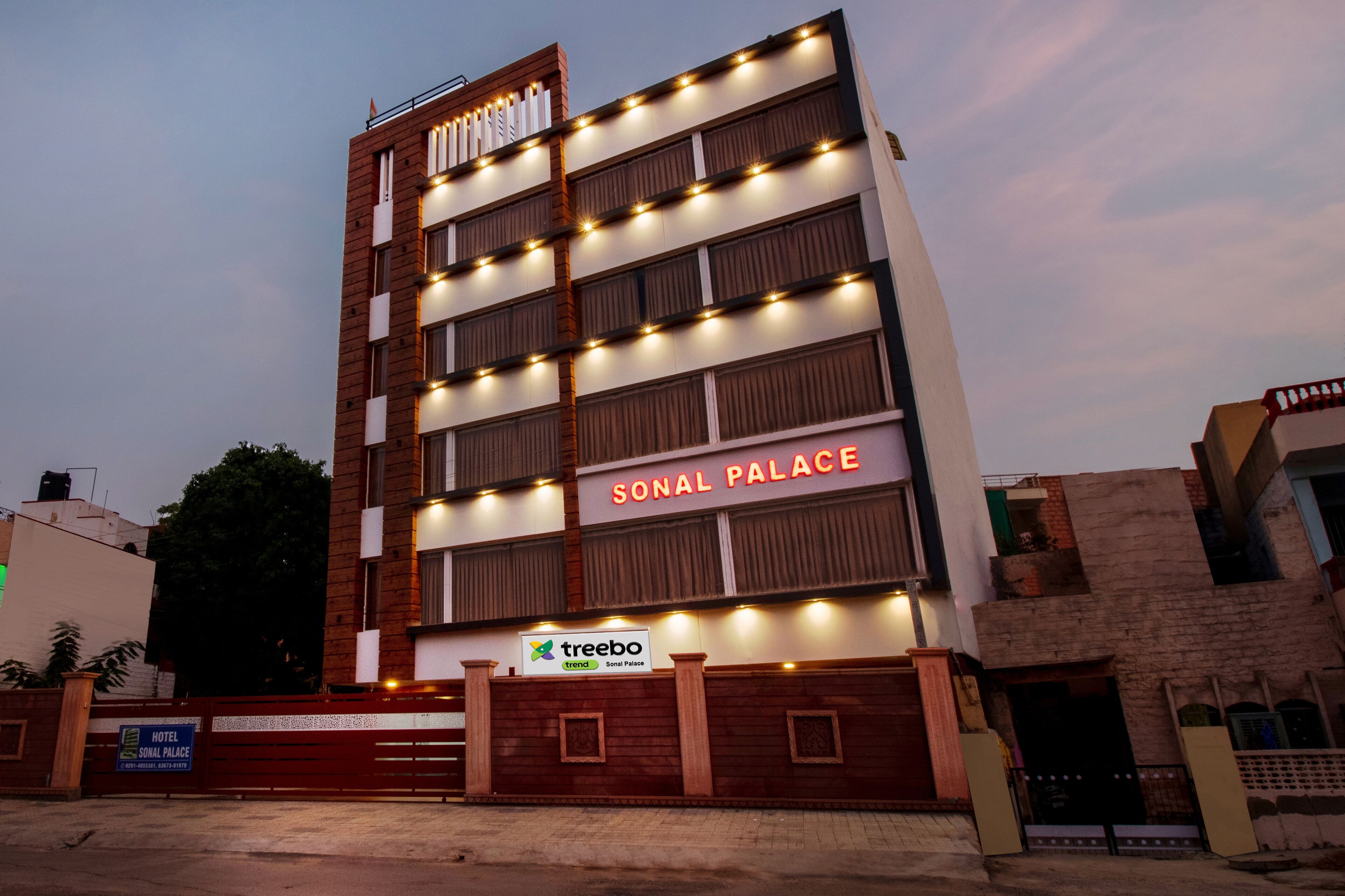 A multi-story hotel named SONAL PALACE with a sign for TREEBO trend.