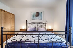 Cozy retreat with a metal-framed bed, bedside tables, and a wardrobe.