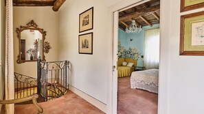 A room with a bed, a chair, a staircase, and a chandelier. - Villa Ribosto, Molazzana, Lucca and Viareggio (Molazzana)