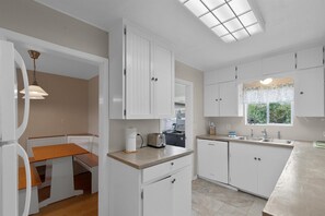 Enjoy cooking in this well-equipped kitchen with appliances and a convenient dining area nearby.