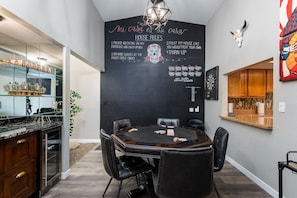 Enjoy meals in this dining area with a wooden table and black leather chairs.