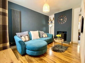 Relax in this stylish living room with a sofa, fireplace, and cozy rug.