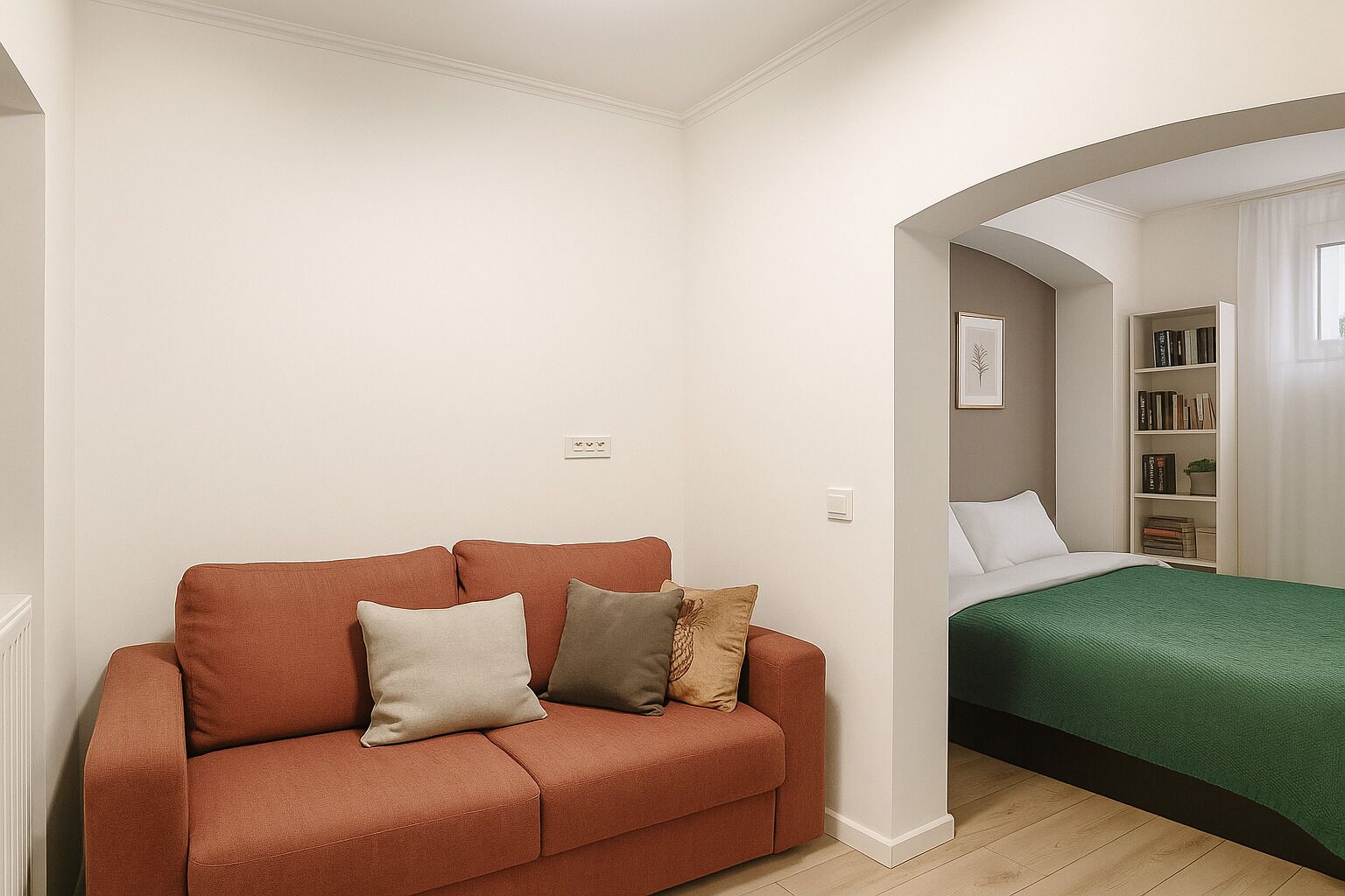 A compact living space with a sofa, a bed, and a bookshelf.