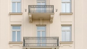 A building with a central entrance, double doors, and a small balcony above.