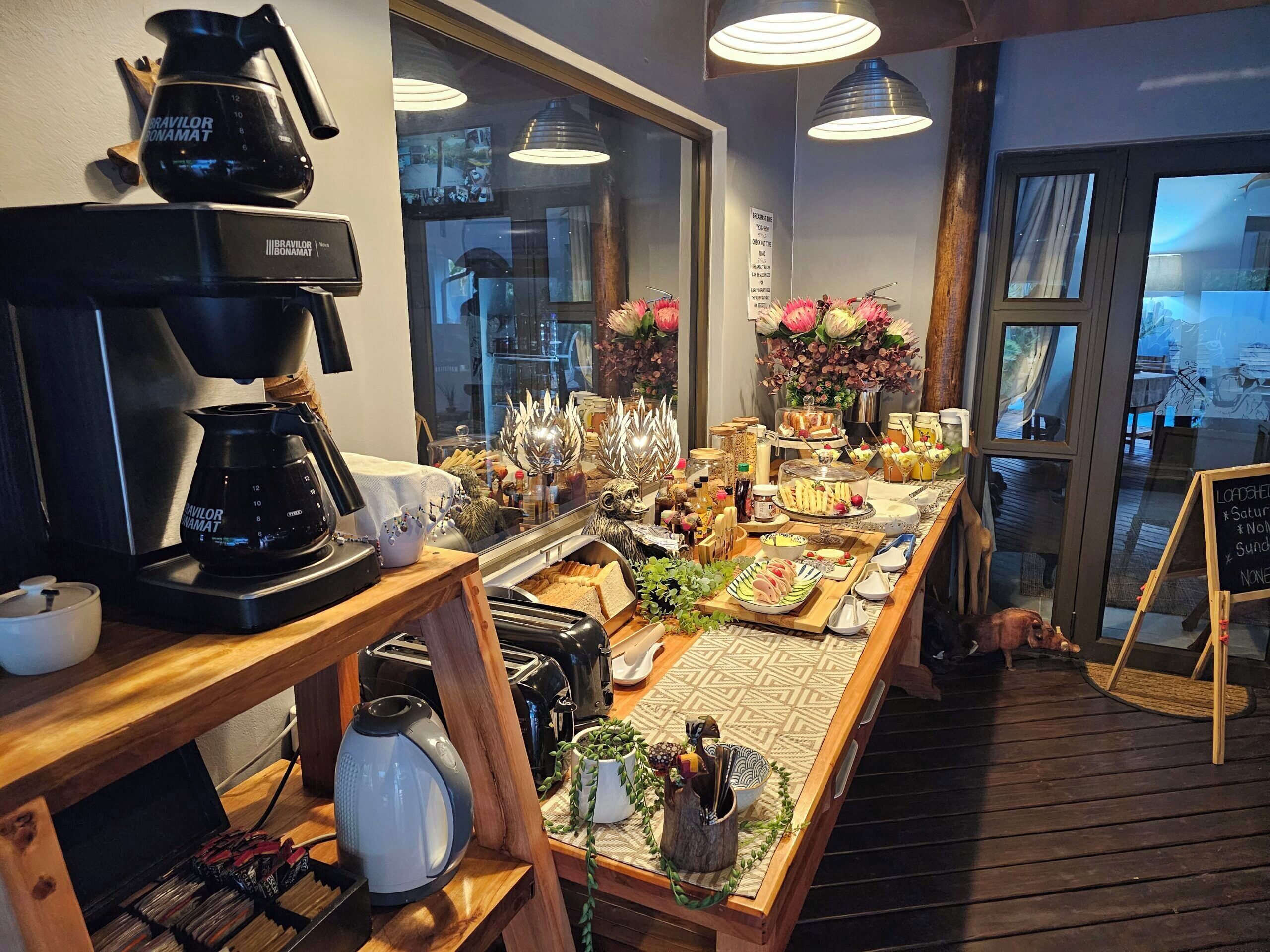 A breakfast buffet with various food items and a coffee station.