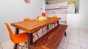 A compact kitchen with white cabinets and a white refrigerator. - Jewel in the sky, joy on the beach: beachfront penthouse, views of El Yunque (Luquillo)