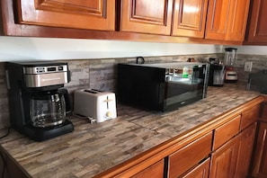 Enjoy cooking in this well-equipped kitchen with a coffee maker, toaster, blender, and microwave.