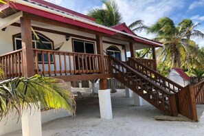 Enjoy stunning ocean views from the covered porch and balcony of this beachfront property.
