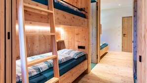 A wooden bunk bed room with a ladder, a single bed, and a door. - Holiday Apartment Hof im Thal Apt Linde with Mountain View, Balcony & Wi-Fi (Aldino)