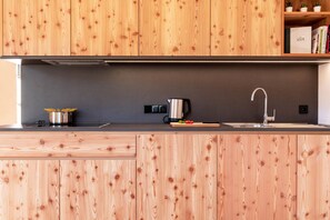 Fridge, stovetop, dishwasher, coffee/tea maker