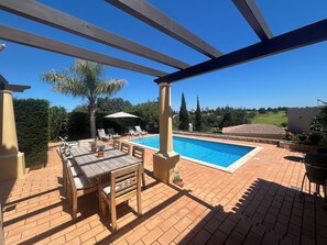A heated pool, sun loungers