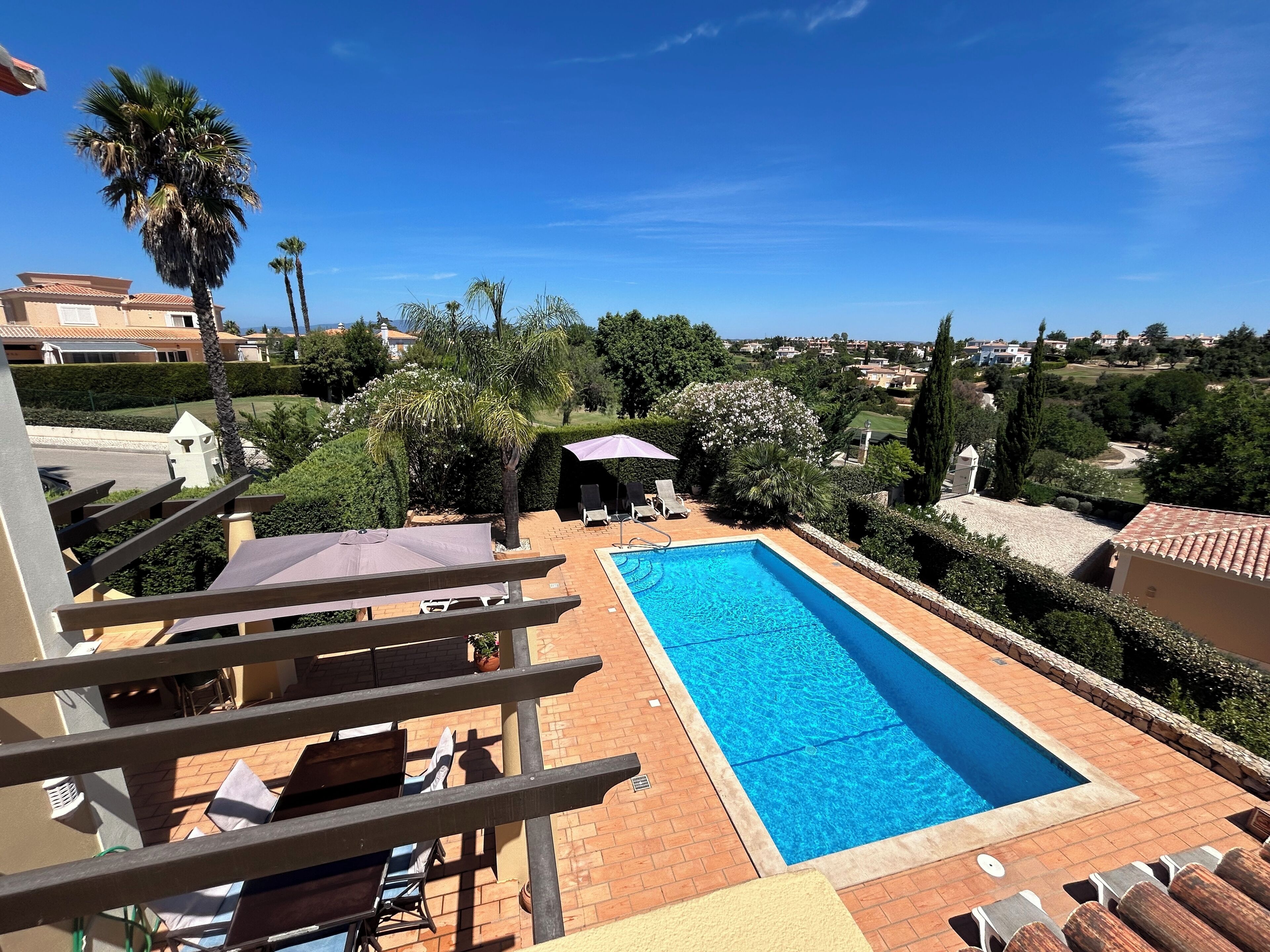 A heated pool, sun loungers