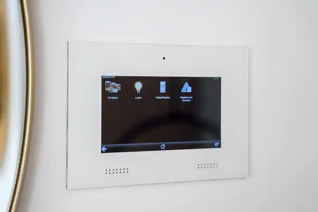 A thermostat with four control options: temperature, lights, video/audio, and settings.