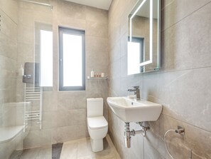 A modern bathroom with a toilet, sink, and shower. - 3 bedroom accommodation in Bryn Pydew, near Llandudno (Bryn Pydew, near Llandudno)