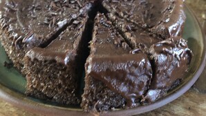 Un gâteau au chocolat, surmonté d’une cerise, posé sur une assiette.