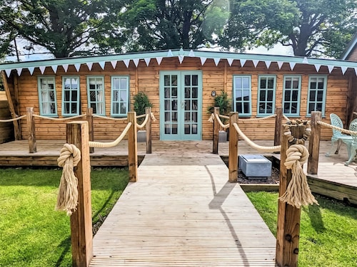 Elegantly finished lodge with a private, decked garden.
