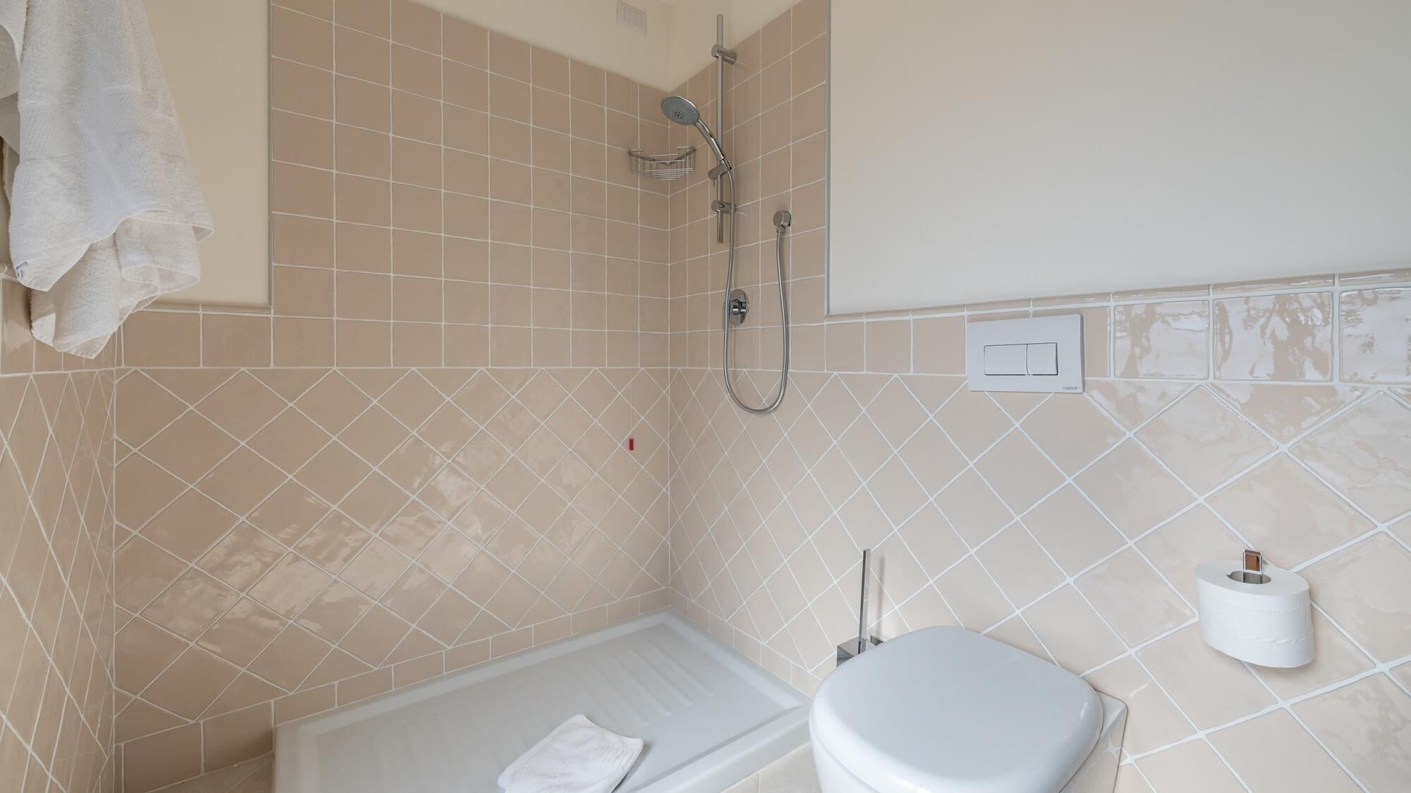 A bathroom with a bathtub, toilet, and shower.