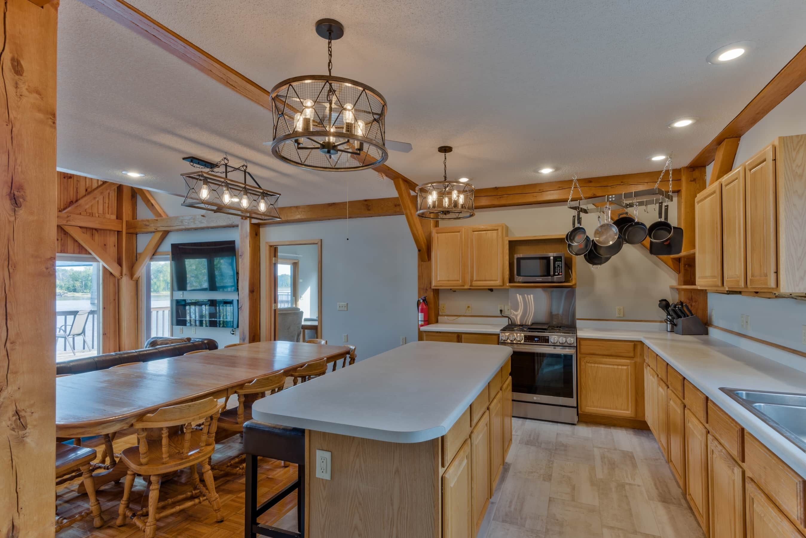 A spacious kitchen with wooden cabinets, a large island, and modern appliances.