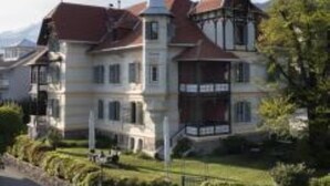 Un grand bâtiment historique, doté de plusieurs étages et d’une tour imposante.