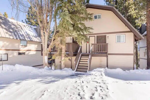 A two-story building with a wooden staircase leading to a balcony. - Alpine Adventure Haven- Walk to Village Gondola, Biking &Trails BTC 10013 (Mammoth Lakes)