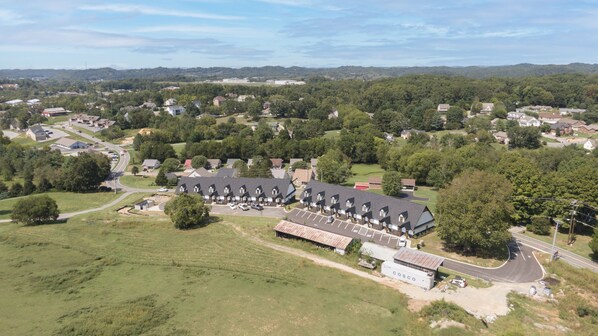 An aerial view of a residential area with a large building labeled "COSCO" and multiple houses.