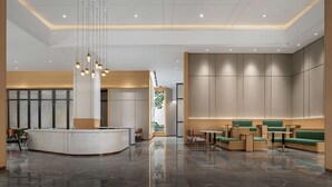 A modern lobby with a reception desk, seating areas, and a large wall with vertical panels. - Hilton Garden Inn Changsha Yuelu (Changsha)