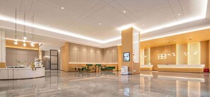 A modern hotel lobby with a reception desk, seating area, and a large digital screen. - Hilton Garden Inn Changsha Yuelu (Changsha)