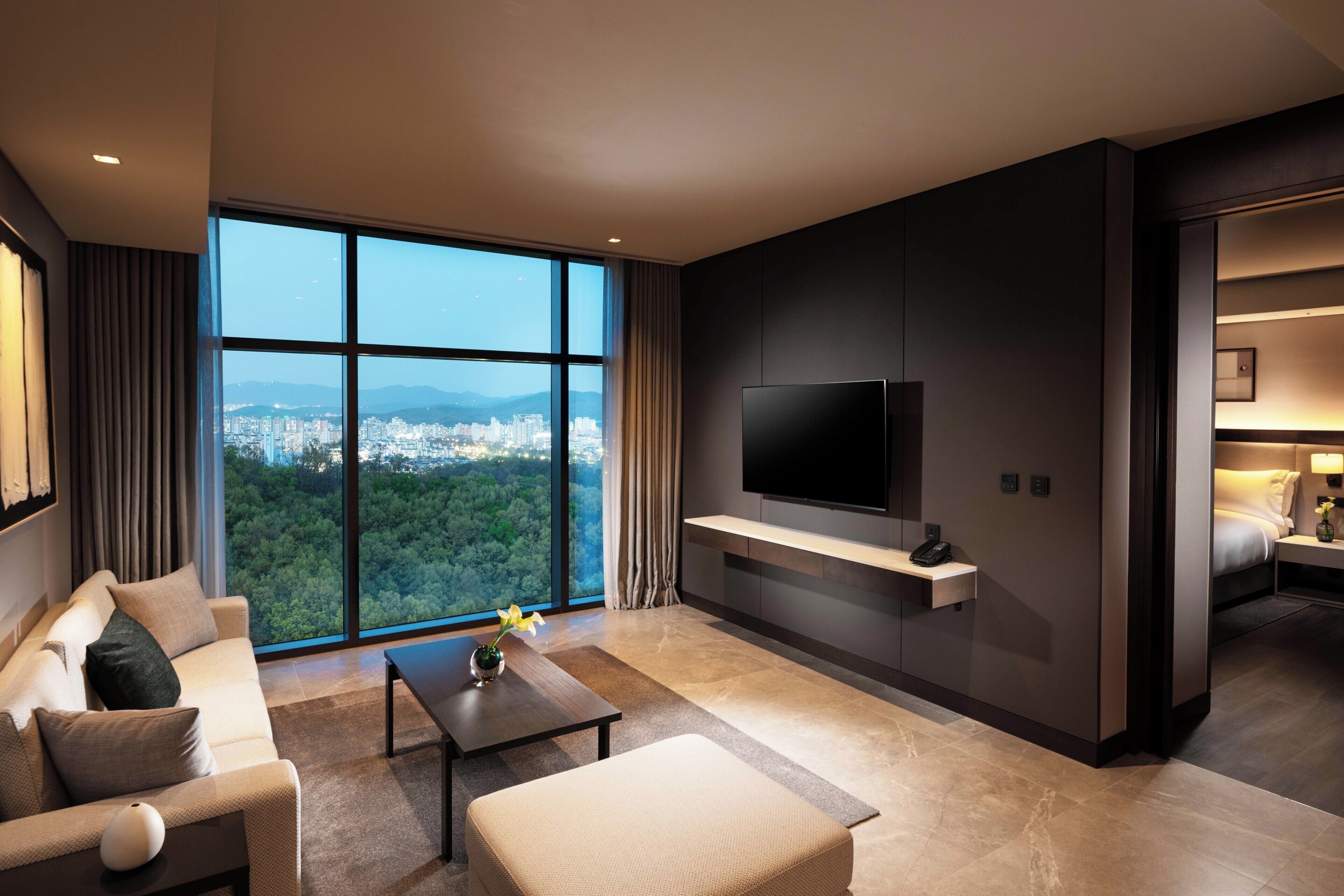 Deluxe, One Bedroom Suite, Forest View | Living area | 55-inch flat-screen TV with cable channels, TV, pay movies